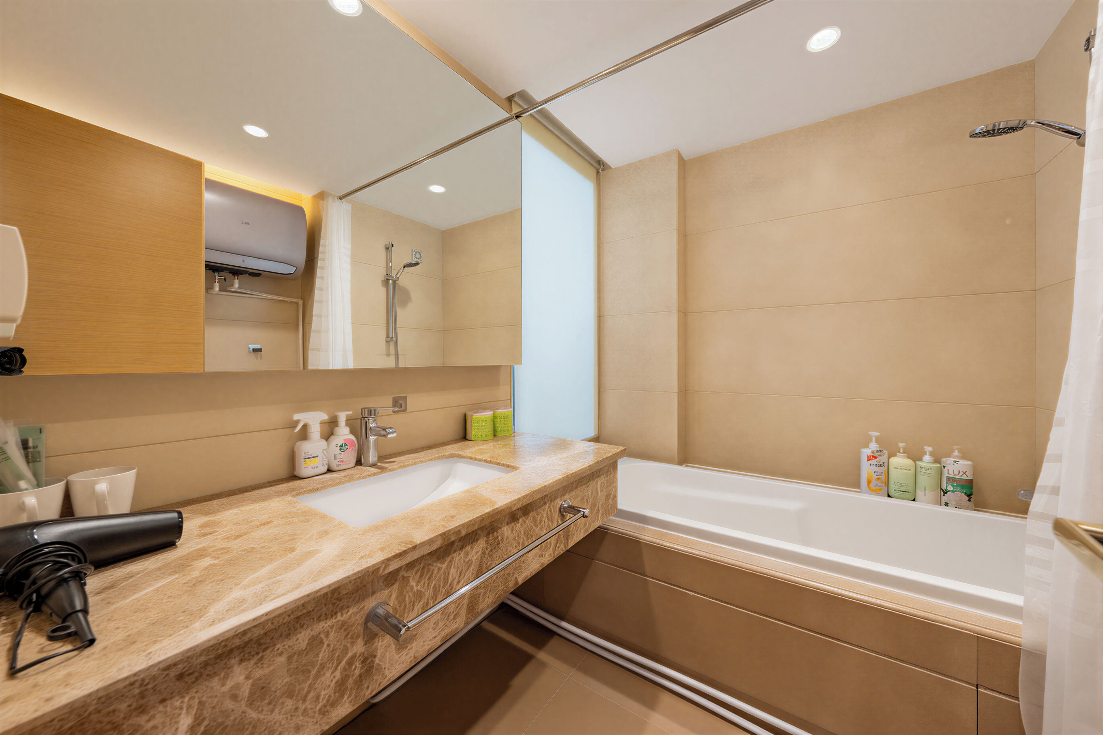 A modern bathroom with a dual sink vanity, a large mirror, a shower, and a bathtub.