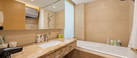 A modern bathroom with a dual sink vanity, a large mirror, a shower, and a bathtub.