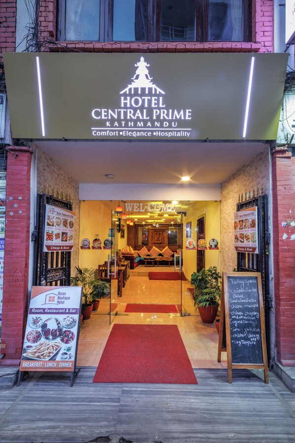 The entrance of Hotel Central Prime Kathmandu with a signboard, a red carpet, and a welcome sign. - Hotel Central Prime (Kathmandu)