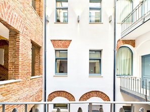 A multi-story building with brick and white facades, multiple windows, and balconies. - Griselini Boutique Suites (Timișoara)