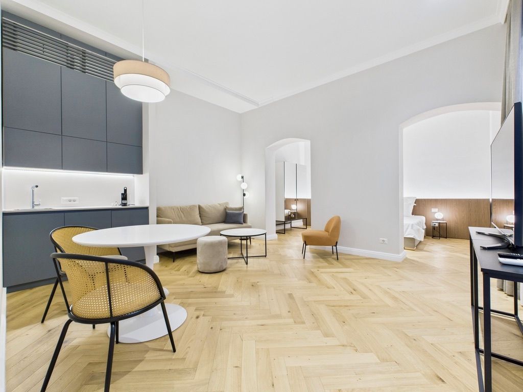 A modern interior with a kitchen, dining area, and living space.