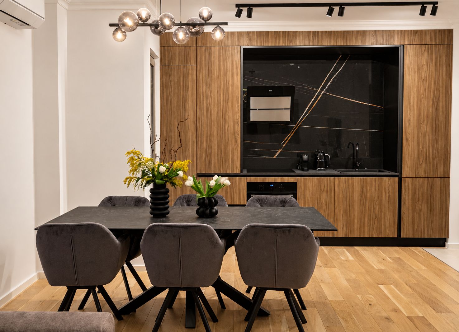 Cozinha moderna com mesa, cadeiras e uma grande janela.