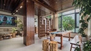 A room with a wooden ceiling, a billiards table, and a large window with a view of greenery. - Zhangjiajie Stone Forest Retreat (Zhangjiajie)
