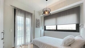 Een slaapkamer met een bed, een raam, een radiator en een plafondlamp.