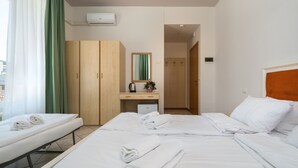 A hotel room with two beds, a wooden wardrobe, a small desk with a mirror, and a view of the outside. - HOTEL MAX  LAZISE (Lazise)