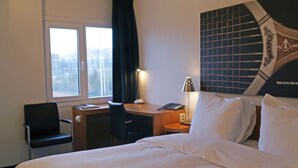 A hotel room with a bed, a desk, a chair, a lamp, a phone, and a window. - A Place You'll Surely Enjoy! Indoor Pool, Near Henriette Polak Museum! (Zutphen)