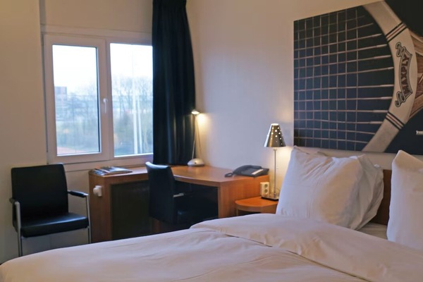 Settle in comfortably with a cozy bed and work desk.