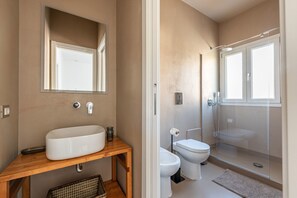 Regadera, bidet, toallas, jabón 