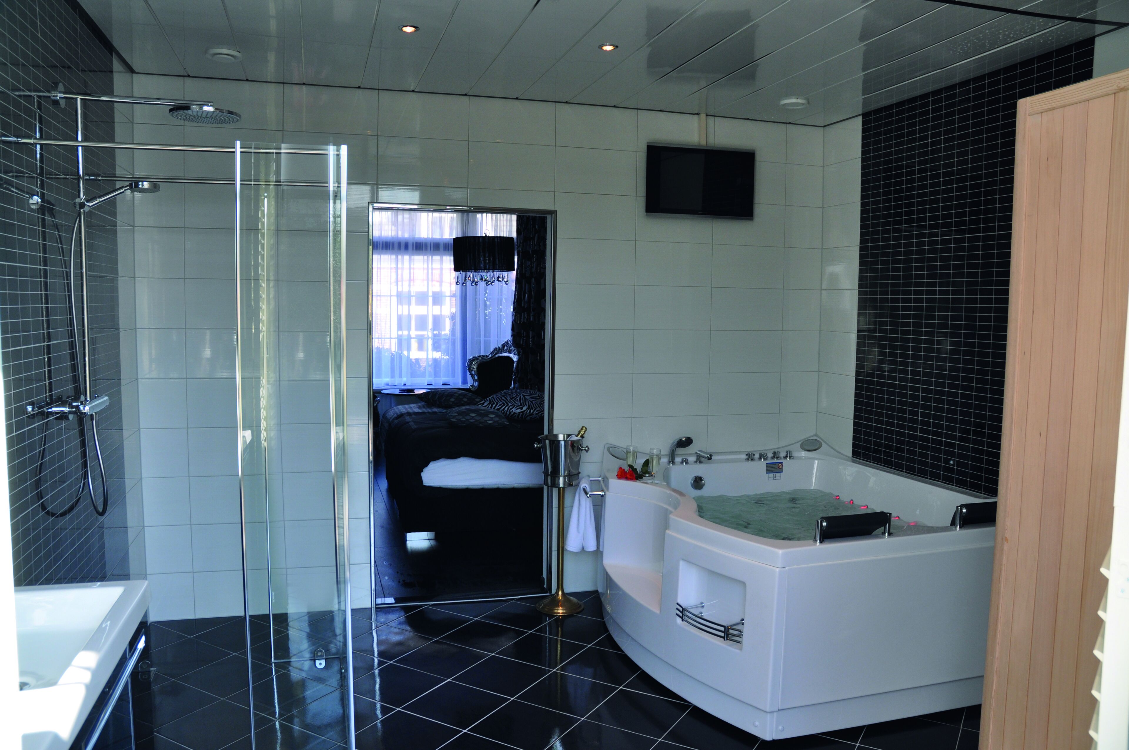 A modern bathroom with a glass shower enclosure, a separate bathtub, and a walk-in shower.