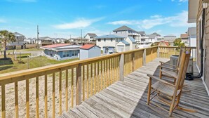 A wooden deck with a view of beach houses and a clear sky. - Spread'N Kindness | Pet-Friendly + One Block from the Beach (Surf City)
