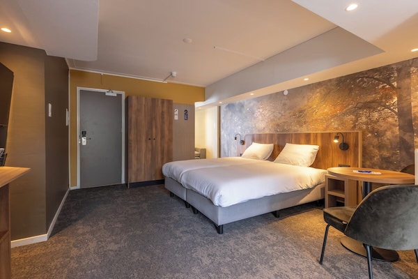 Unwind in a spacious room with warm, ambient lighting.