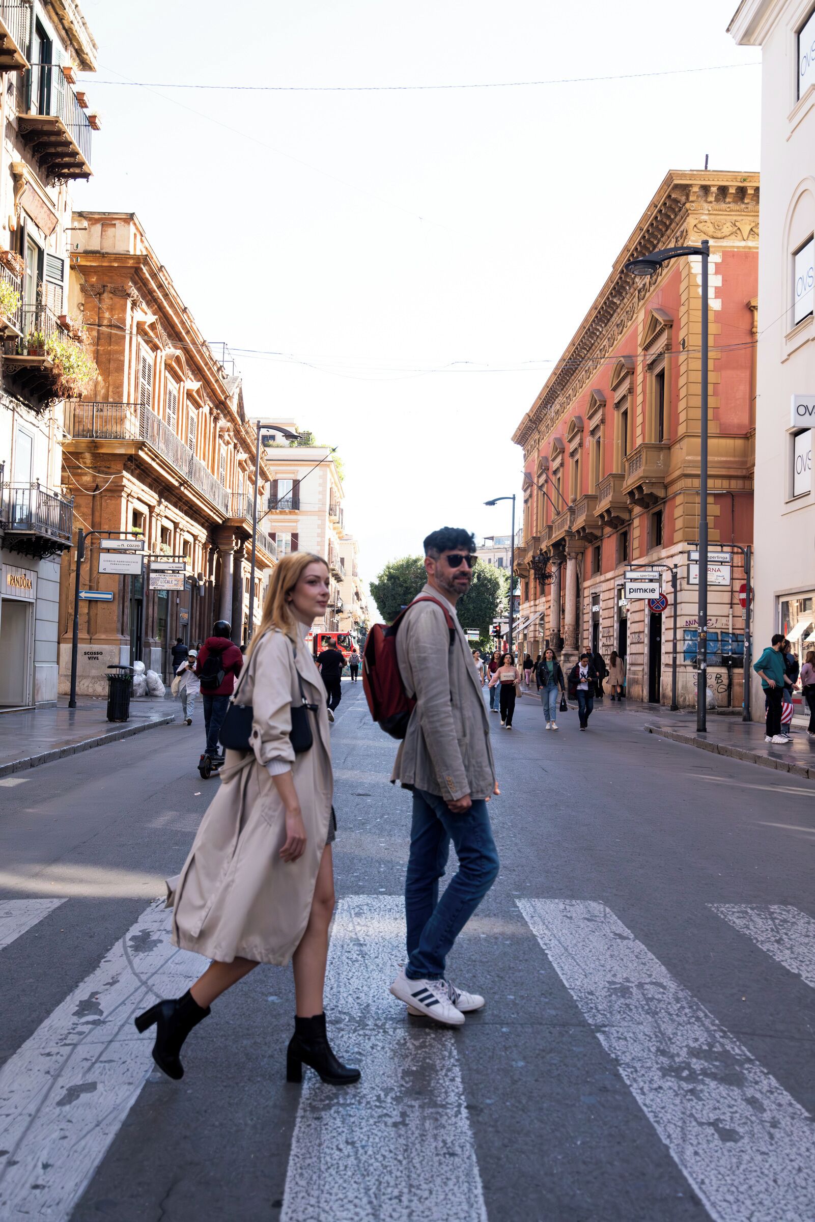 A street scene with pedestrians, buildings, and a crosswalk.