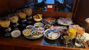 A breakfast buffet with various food items and beverages. - Barcaldine Castle (Oban)