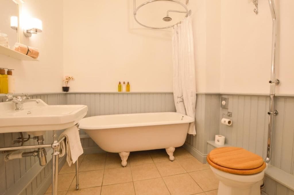 A bathroom with a freestanding bathtub, a sink, a toilet, and a shower.