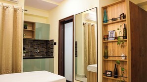 A bathroom with a shower, a toilet, a sink, and a mirror. - C Suites Gilbert (Bengaluru)