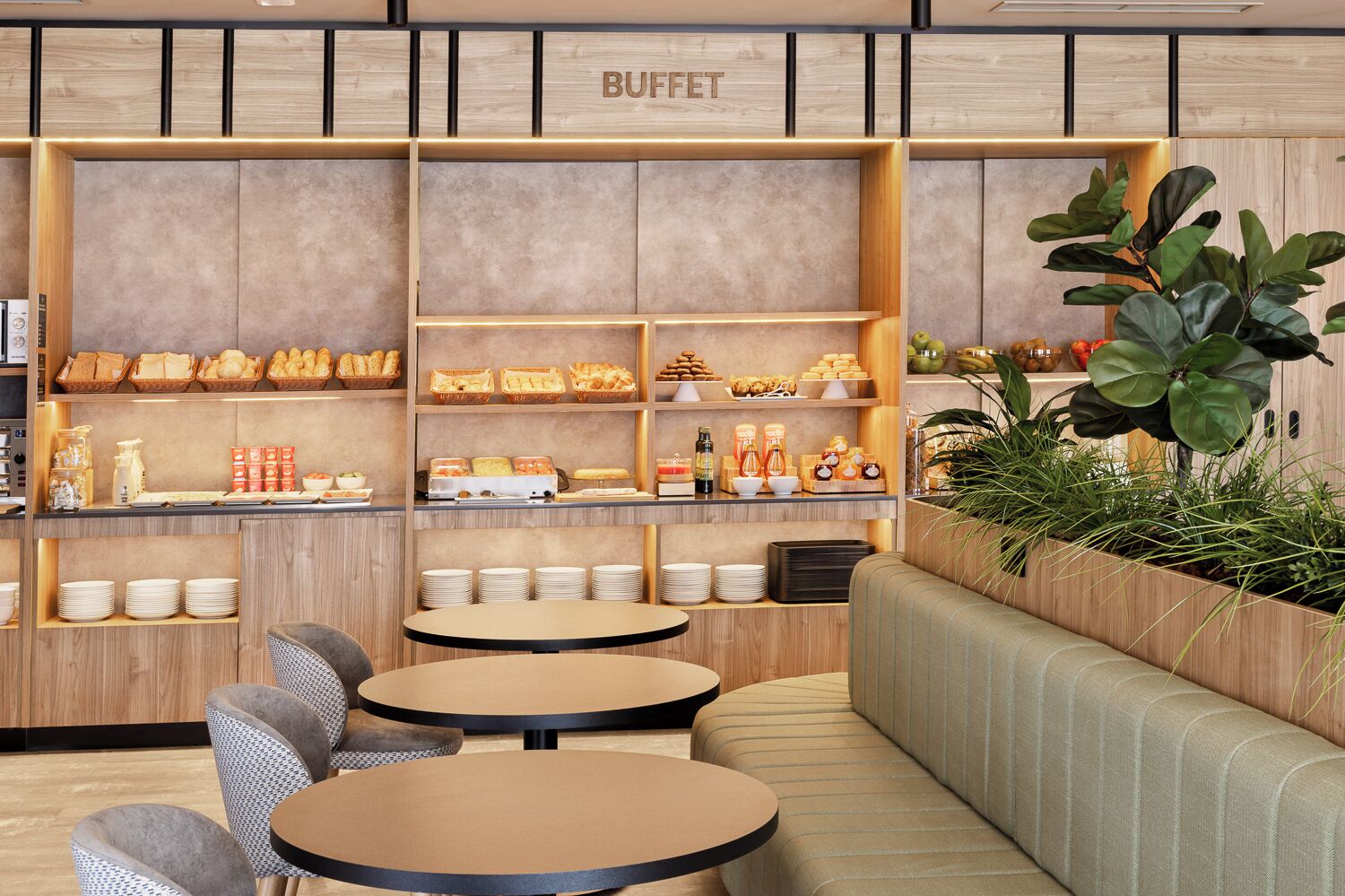 A buffet area with multiple shelves of food, seating arrangements, and a wooden wall with the word 'BUFFET' visible.
