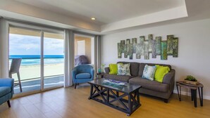 A living room with a sofa, armchairs, a coffee table, and a view of the beach. - 30+ Stay! Oceanfront, Great For Families W/Parking (San Diego)