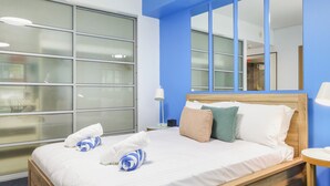 A hotel room with a large window, a bed with white linens, and a wooden headboard. - The Complete Studio | King Bed | Kitchen Laundry (Darwin City)
