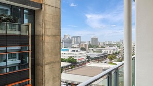 A high-rise building with a view of a cityscape, including various buildings and a clear sky. - The Complete Studio | King Bed | Kitchen Laundry (Darwin City)