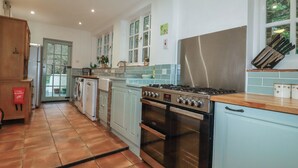 A kitchen with a stove, oven, and dishwasher. - Lost In The Woods Lodge (Bodmin)