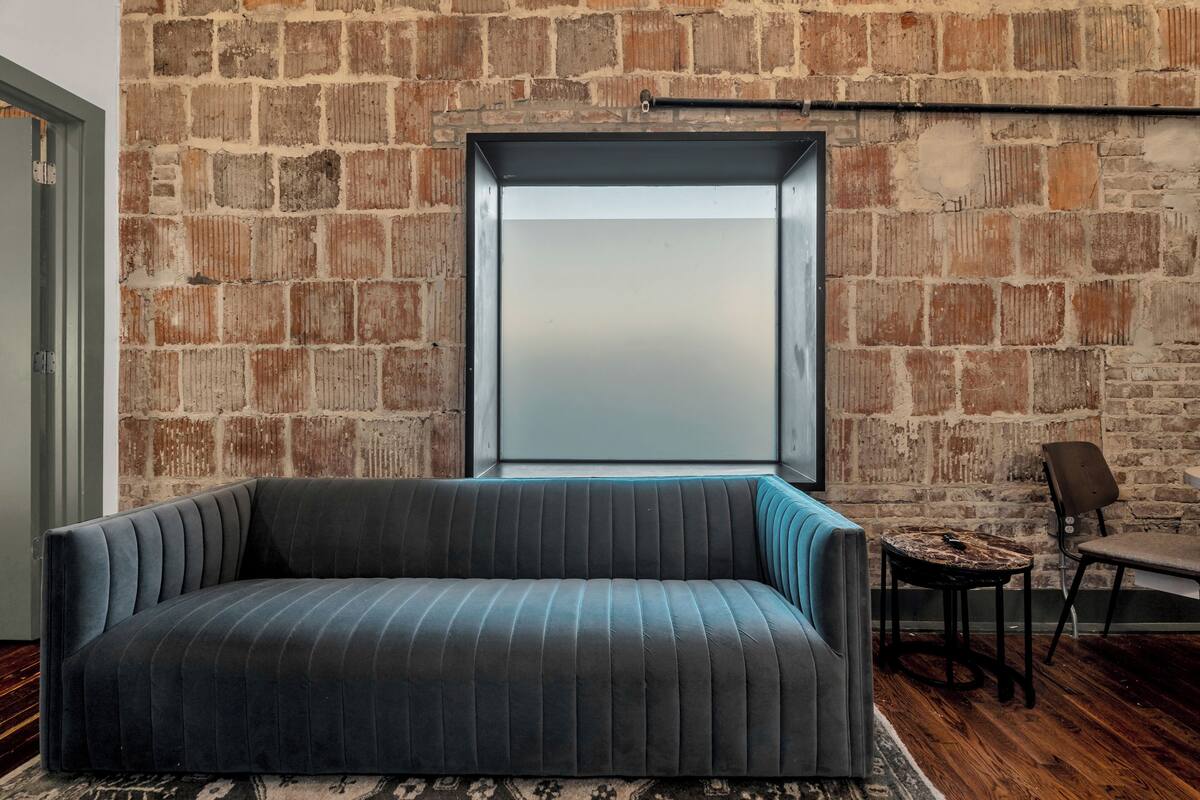 A modern living room with a sofa, a small table, and a chair.