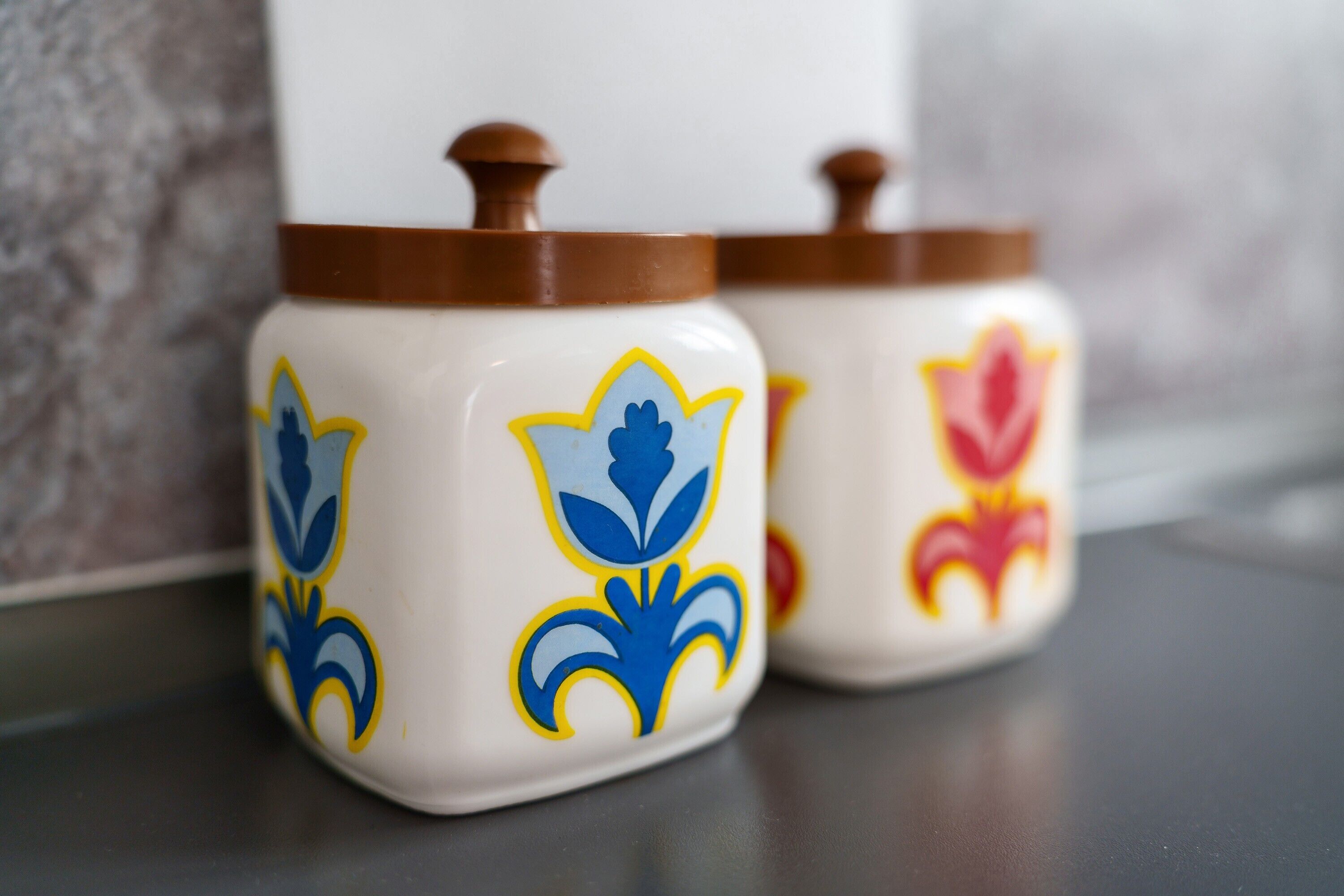 Three ceramic containers with lids, featuring floral designs.