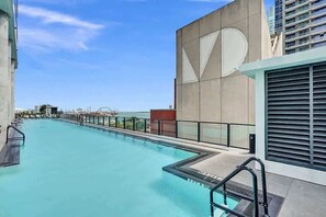 A rooftop swimming pool with a clear view of the city skyline. - High-Rise Miami Studio | Rooftop Pool & Gym (Miami)