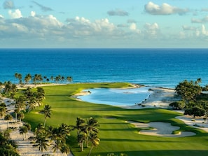 A golf course with a view of the ocean and palm trees. - ®{The~Beach~Essence} @Tanama,Capcana +Pool+Gym+BBQ (Punta Cana)