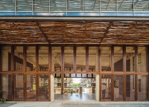 A building with large windows and a wooden slatted ceiling. - Stunning 2BR Jungle Oasis Tulum | Gym | Coworking (Tulum)
