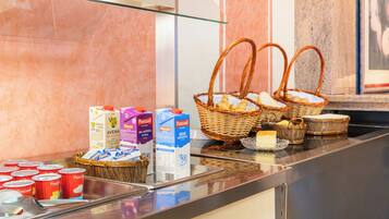 A breakfast buffet with various food items and beverages.
