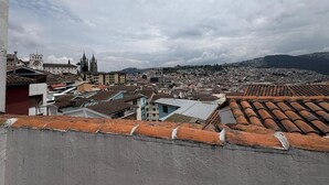 A cityscape with a variety of buildings, including a prominent church with two spires, and a mix of residential and commercial structures. - Your refuge in the Historic Center of Quito (Quito)