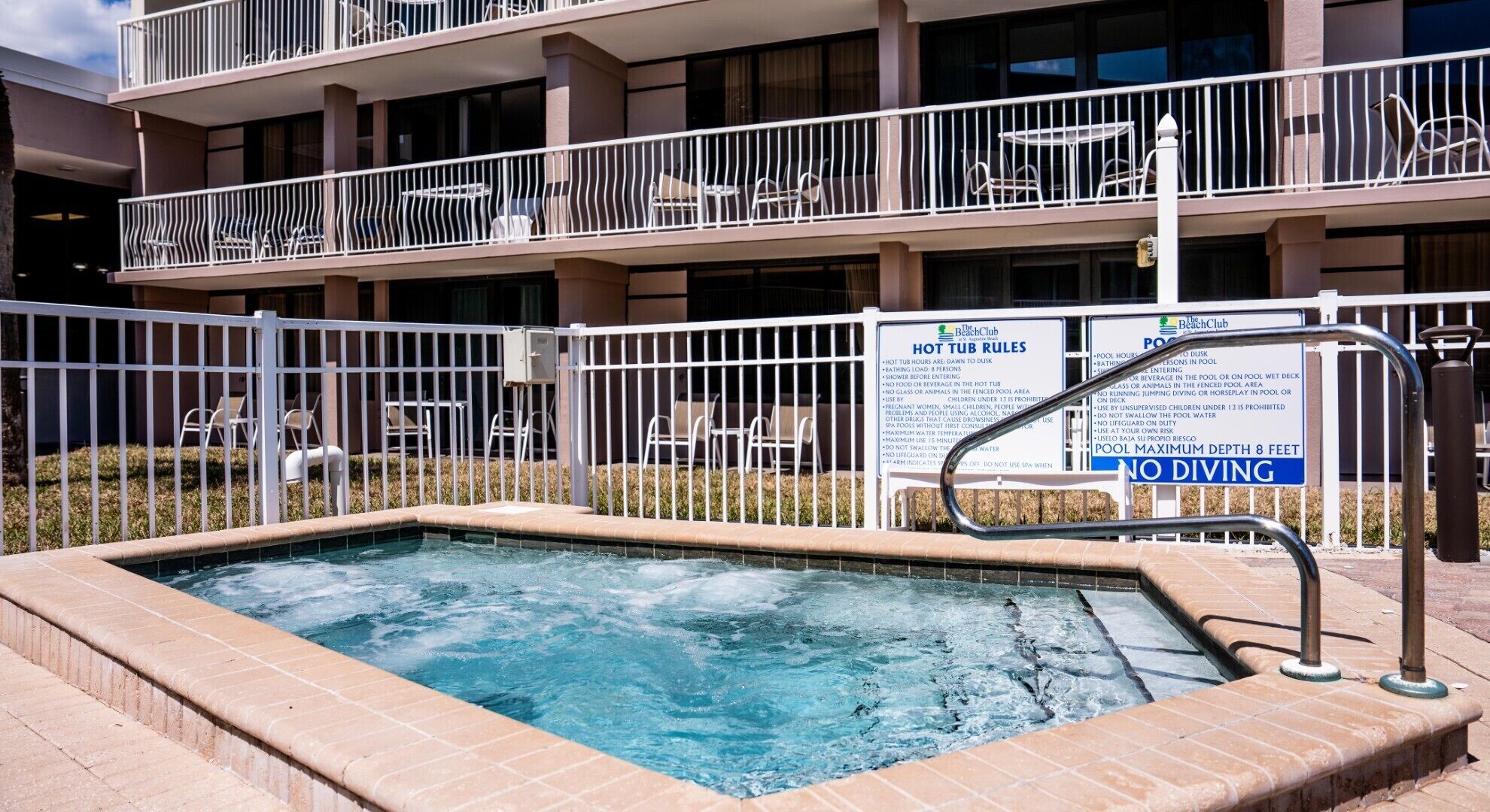 Un bain à remous avec un panneau indiquant « IL EST INTERDIT DE PLONGER » et « PROFONDEUR MAXIMALE DE LA PISCINE : 2,4 MÈTRES » (8 pieds).