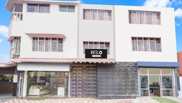 A two-story building with a sign reading 'HOTEL & Company Services.' - Hotel O Pradhan Nagar Prince Guest House (Siliguri)