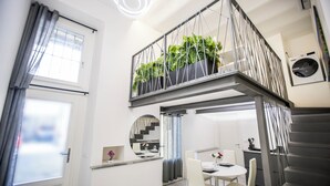 A modern apartment with a balcony, a dining area, and a staircase. - Volta House by DM (Como)