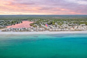 An aerial view of a coastal town with beachfront properties and a marina. - New 30A Gulf Views • Steps to Beach (Santa Rosa Beach)