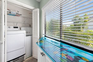 A laundry room with a washing machine, drying rack, and a window with blinds. - 🌊Great Location | Walk to Beach | 2 Pools | Crystal Village II 26A⛱️ (Miramar Beach)