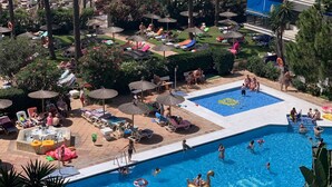A pool area with multiple swimming pools, lounge chairs, and umbrellas. - 0. Skol Marbella 507A (Marbella)