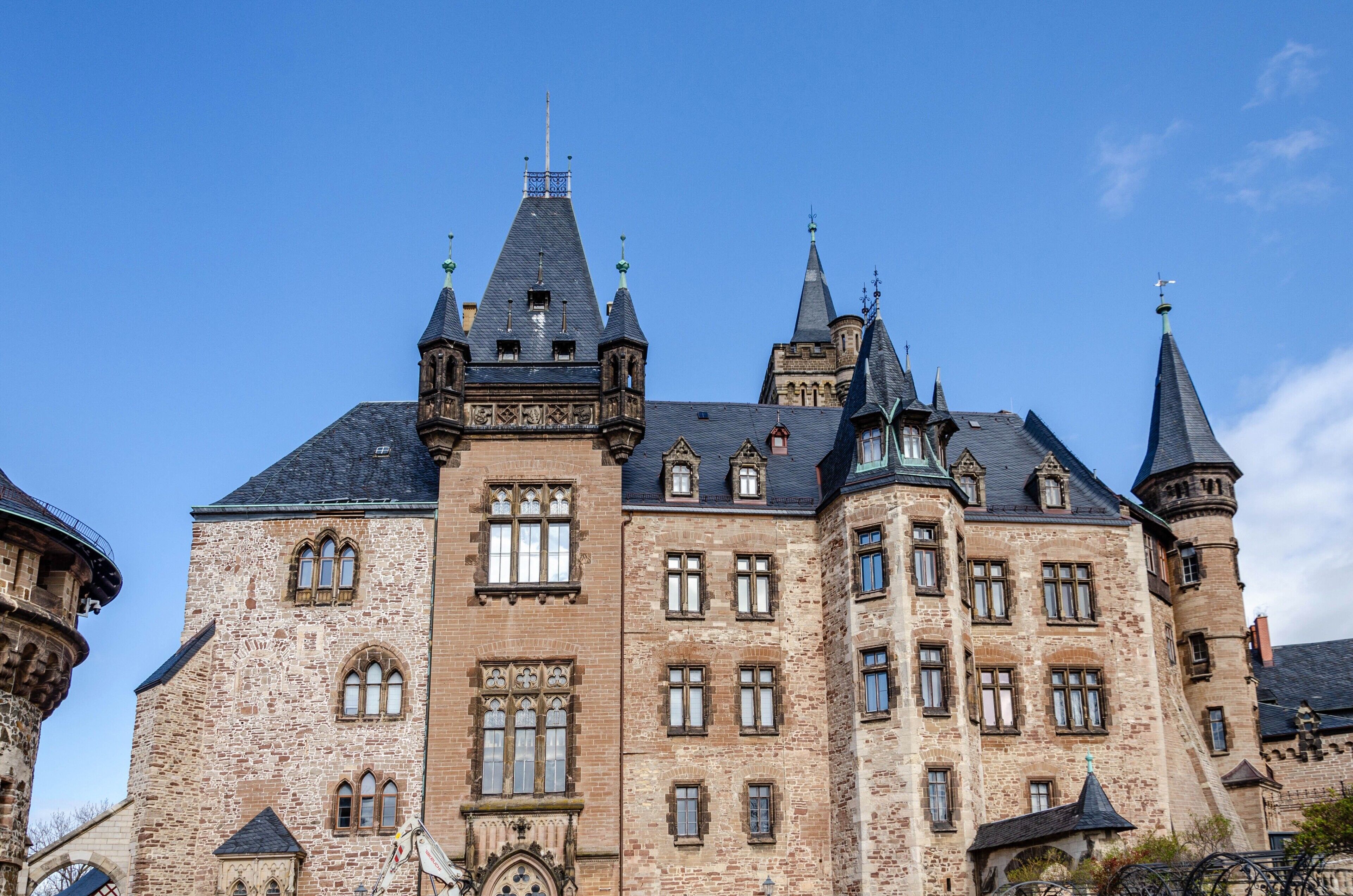 A historic building with multiple towers and arched windows.