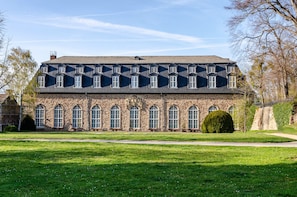 A large stone building with multiple arched windows and a symmetrical facade. - Holiday Apartment for 2 People (42 m²) in Wernigerode (Wernigerode)