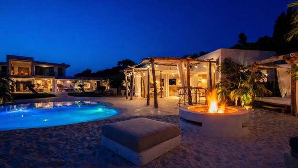 A pool area with a fire pit, outdoor seating, and a building with multiple rooms. - Luxury Villa West Nice (Nice)