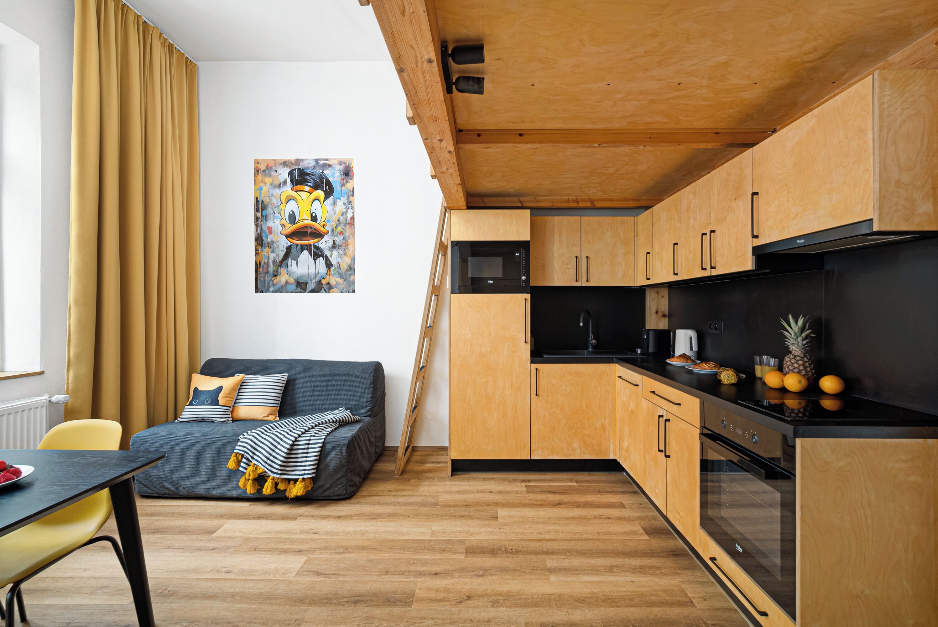 A modern kitchen with wooden cabinets, a black microwave, and a stainless steel refrigerator.