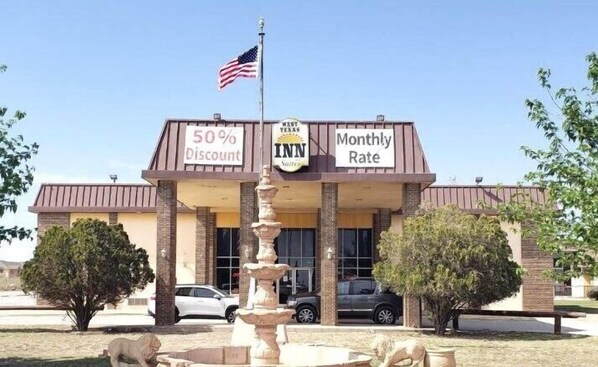 A building with a sign indicating a 50% discount and a monthly rate.