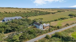 A rural property with two main buildings, a road, and surrounding fields. - 3 Bed in Tramore (oc-ii11304) (Tramore)