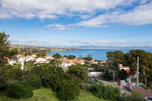 Un pueblo costero con casas, cielo despejado y vista al mar.