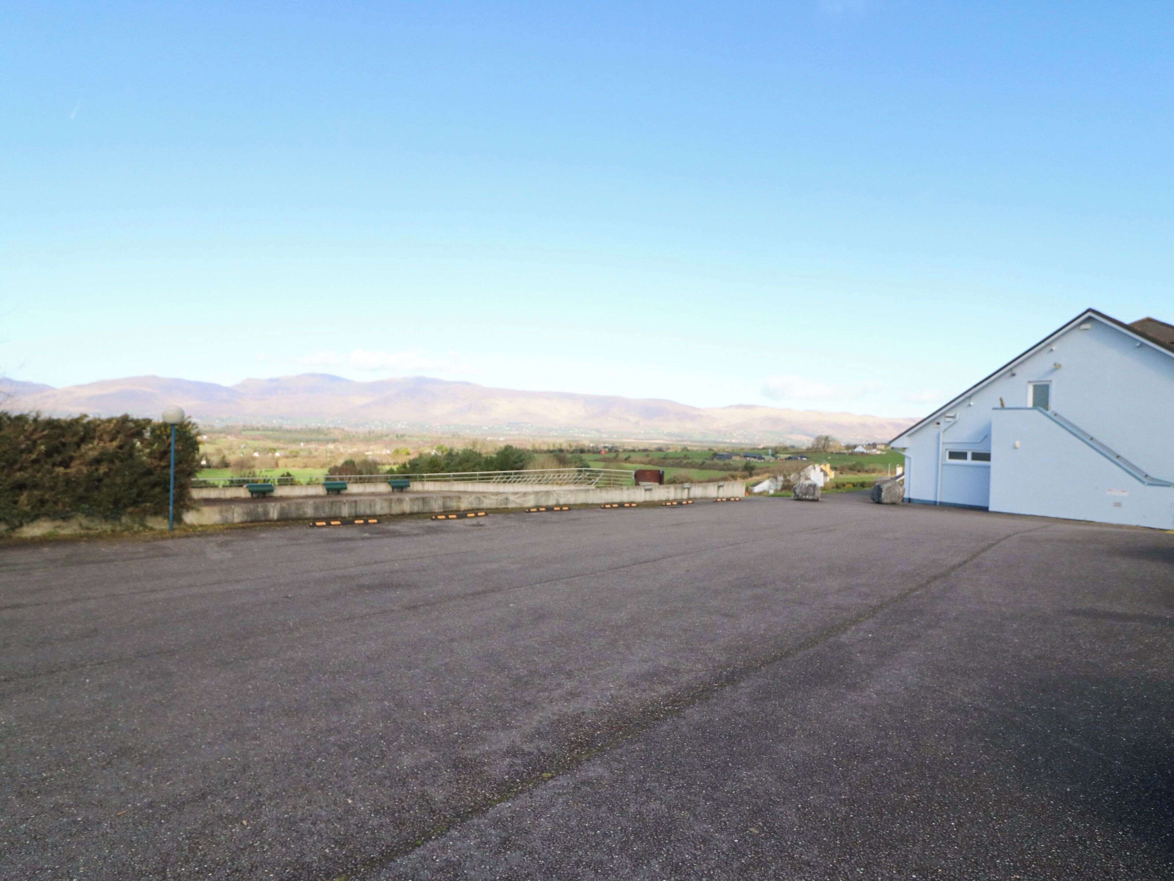 A large, open paved area with a building on the right.