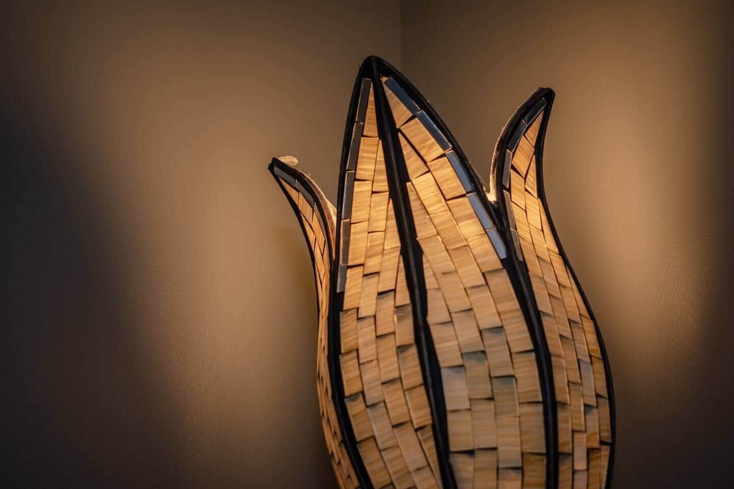 A wall-mounted lamp with a woven design.