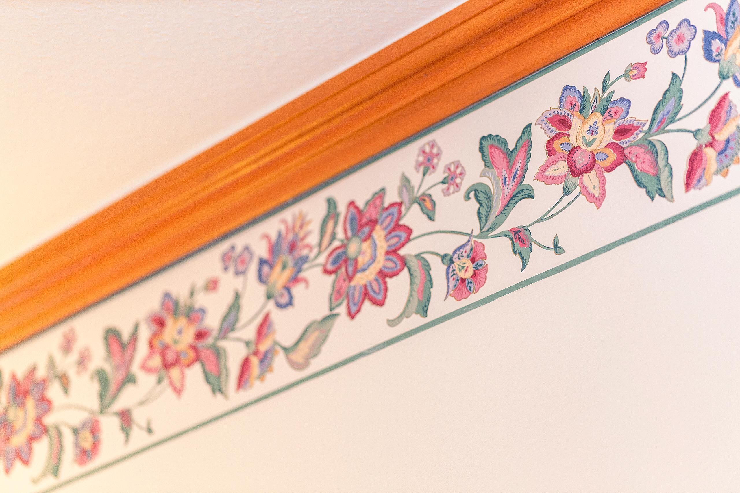 A decorative floral border on a ceiling.