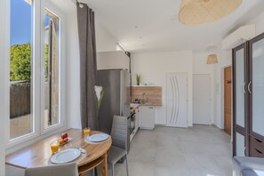 A modern kitchen with a refrigerator, sink, and wooden countertop. - Frgk Suquet Olivier 1-Bedroom Apartment with Charm and UltraFast WiFi (Cannes)