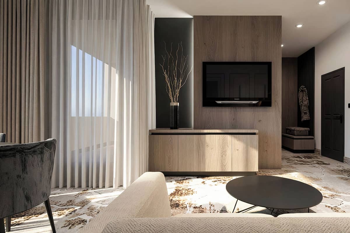 A modern living room with a sofa, a coffee table, a dining area with a table and chairs, a TV mounted on a wooden wall, and a large window with curtains.
