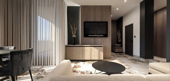 A modern living room with a sofa, a coffee table, a dining area with a table and chairs, a TV mounted on a wooden wall, and a large window with curtains. - Hotel Galaxy Timisoara, A Member Of Radisson Individuals (Timisoara)